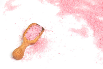 Pink salt isolated in scoop on white background. selective focus or blurry.