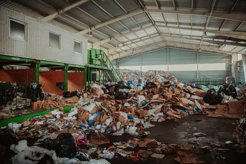 large piles of unsorted waste at the waste sorting center