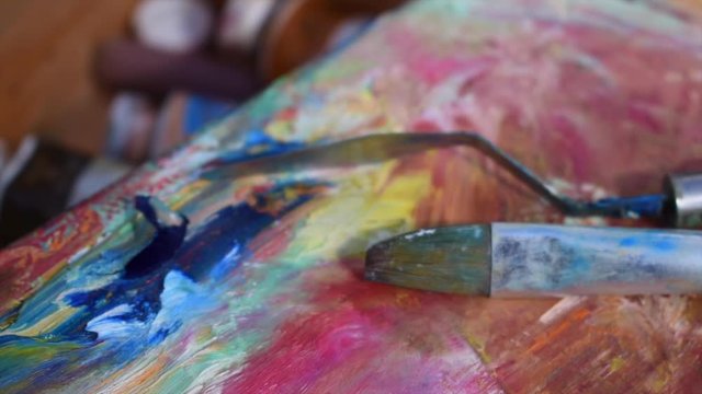 the artist's tools. brush and palette knife on canvas