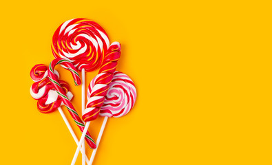 Colorful lollipop on yellow background.
