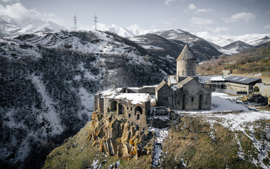 old Armenian Christian stone Church in the snow on the mountain in winter