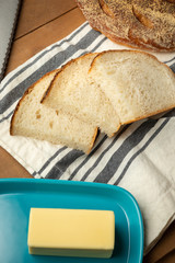 Sliced sour dough bread beside a butter dish, with space for text