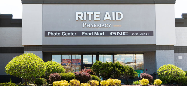 Rite Aid Pharmacy stores exterior with trees and bushes in front