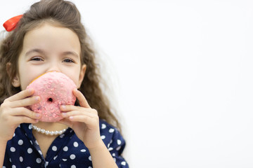 Little girl hiding behind a pink donut.