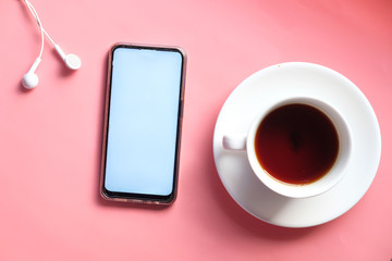 Top view of smart phone with empty screen on pink background 