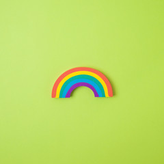 Obraz premium Rainbow symbol over green background. Concept of hope during coronavirus COVID-19 pandemic