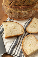 Flat lay on freshly sliced sourdough bread, in a home baking scene
