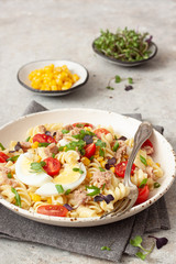 Pasta salad with vegetables, egg and tuna on  table