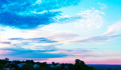 Fototapeta na wymiar Beautiful sunset. Magical pink-blue-white sunset on a blue sky. Picturesque beautiful sunset sky