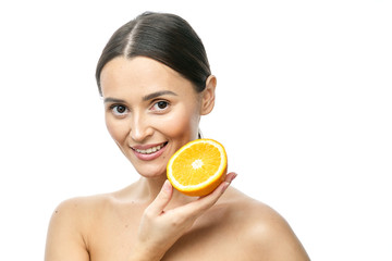 Close up beauty portrait of an excited attractive half naked woman holding orange slices at her...