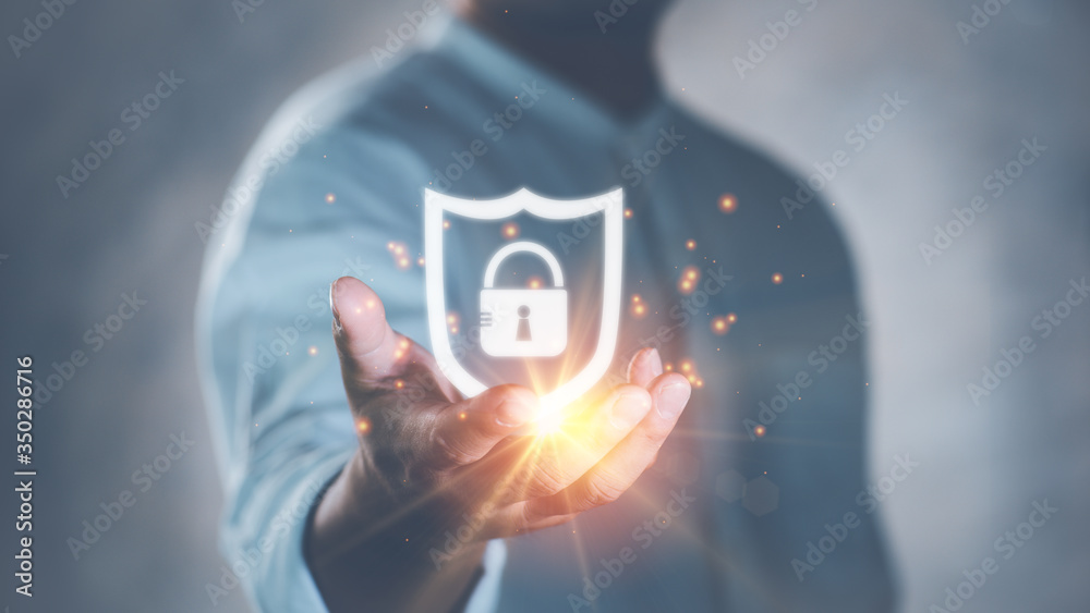 Poster Cyber security safe data protection business technology privacy concept. Businessman holding shield protect security icon security on the virtual display.Information security system.