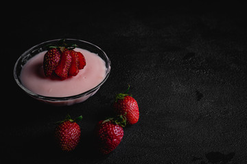 Strawberry pudding on dark background