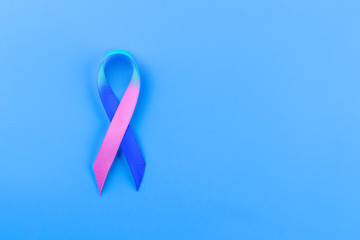 ribbon symbolizing World Thyroid Day on a blue background, copy spaсe