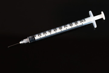 Closeup macro hypodermic syringe
and drop water vaccine for anti Covid corona virus, Hope to success vaccine atnti virus