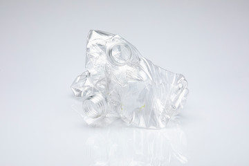 Duo of pellucid plastic bottles without cap crushed on themselves, isolated in front of a white background