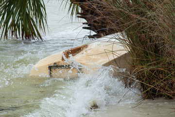 Capsized row boat on coast