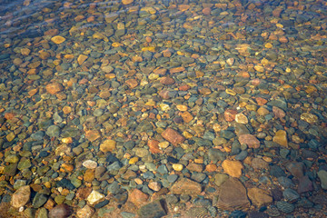 
stones underwater in shallow lake