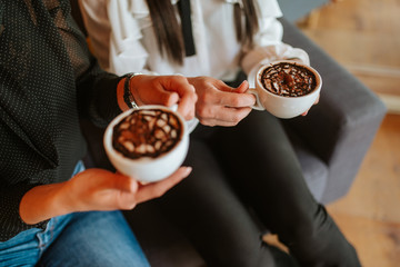 Close up of hands business women with cups of coffee