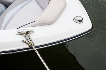 View of the bow of a moored motor boat on the dock hobby small yacht snow white luxury boat rental sports boat vacation leisure relaxation