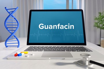 Guanfacin. Laptop mit Begriff/Text auf Monitor. Computer von Arzt. DNA und Stethoskop. Medizin, Gesundheitswesen