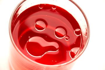 muzzle of drops in a glass with a drink