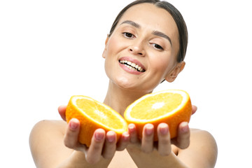 Close up beauty portrait of an excited attractive half naked woman holding orange slices at her...