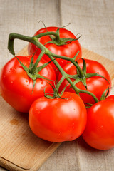 Juicy red tomatoes on a cutting board