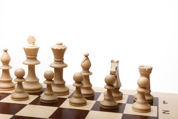army of white chess pieces on the board at the beginning of the game on white background. 