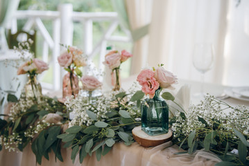 Flowers and greenery as a decoration of wedding table