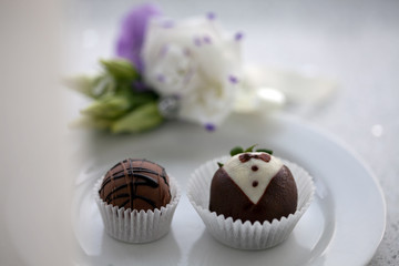 Wedding dessert. Chocolate candies on a white saucer