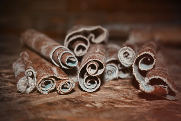 Abrasive paper. Sanding paper lies on an old wooden table. Blurred background. Soft focus. Underlined curly sheets of used sand cloth. Beautiful background