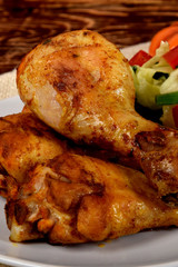 fried chicken legs and green salad with sunflower seeds