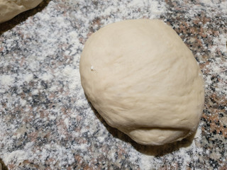 homemade dough on dusted flour - top view