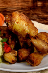 fried chicken legs and green salad with sunflower seeds
