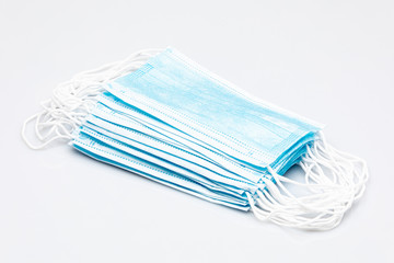 stack of blue surgical masks isolated on a white background