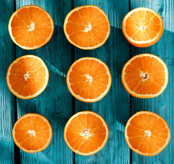 Fresh orange fruits on desk of blue color and summer time 
