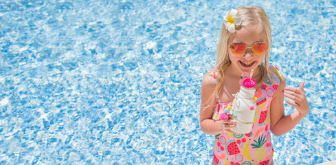 Pretty little girl in swimming pool, summer vacations.