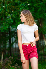 Fototapeta premium Portrait of a young blonde girl in white t-shirt