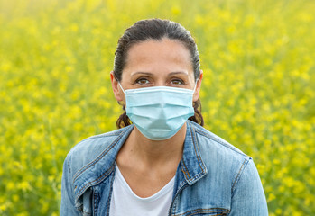Brunette woman with a mask in the countryside