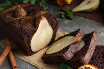 Tasty pear bread with cinnamon on grey table, closeup. Homemade cake