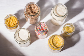 bulk products in zero waste shop. cereal and candies in glass jars on shelves. Eco friendly shopping in plastic free grocery store.