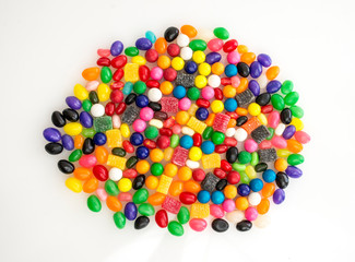 Large cluster of different-colored jelly beans and other small candies..