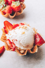Vanilla Ice Cream Scoops with strawberry pieces into the waffle basket, easy dessert at home