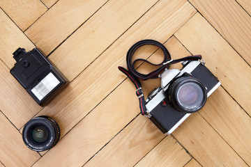 Old camera and photographic equipment on wooden floor
