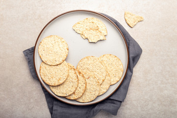Healthy Snack from Free From Gluten and Free from Milk Crackers on Light Background. Tapioca, maize and soya crackers with sea salt and cracked black pepper