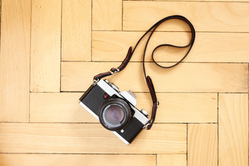 Old reflex camera with strap on the floor - 350307566