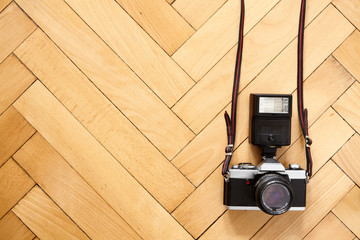 Old camera with flash lamp on wooden  floor - 350307931