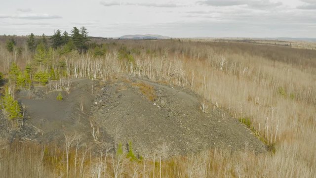 Slate remnants of old quarry in Monson, Maine aerial push in 