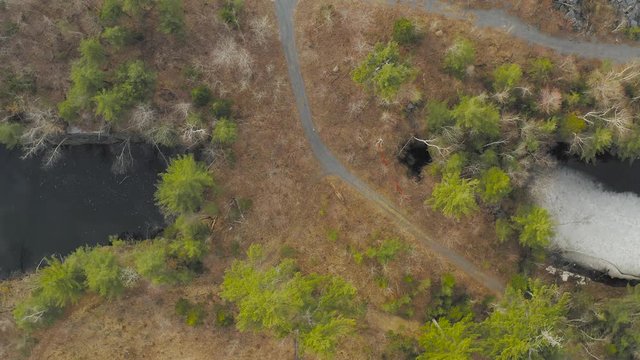 Ascending aerial over road into abandoned slate mine Monson, Maine 