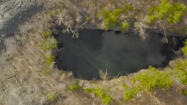 Open slate pit mine abandoned sky reflection in water Aerial view 